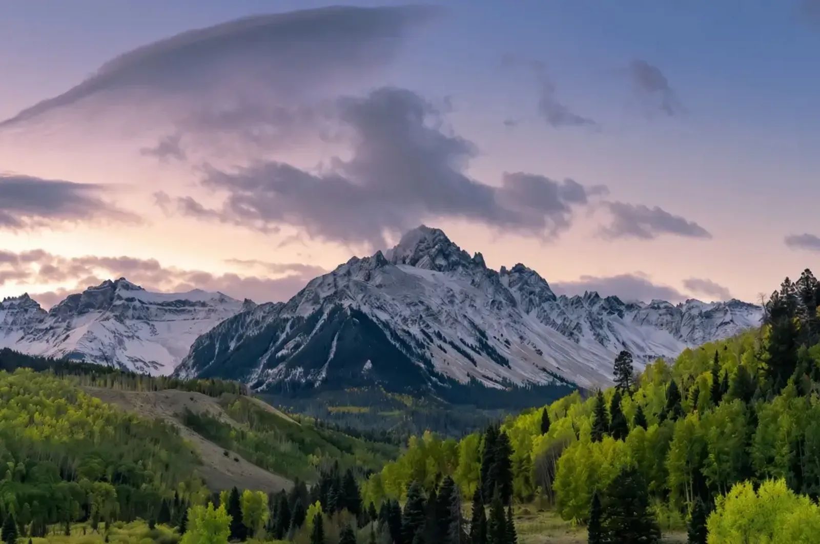 Mist over forested mountain ridges
