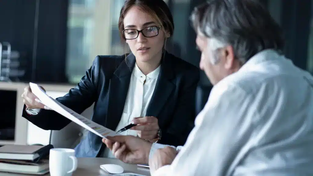 A business owner discusses a contract before signing up to grow his business online with SEO.