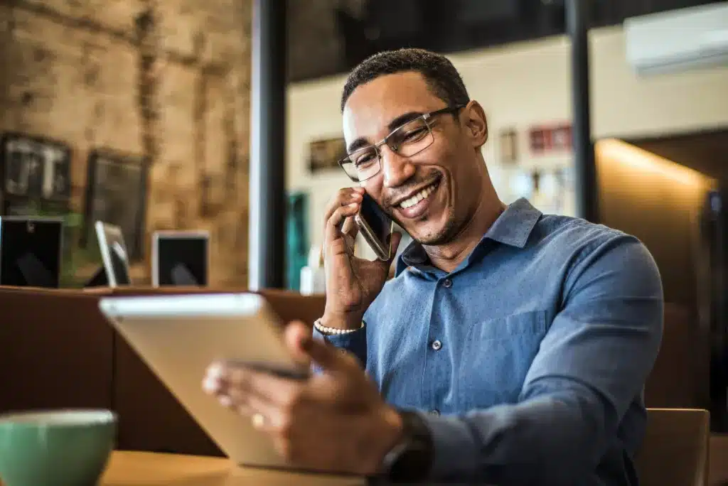 A business owner talks with an SEO team on the phone to learn how an SEO company works and communicates.